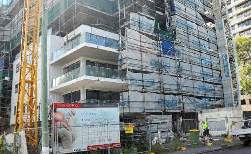 Workers have begun boarding up the stalled Beaches high-rise apartment block on Ocean Parade. Workers have begun boarding up the stalled Beaches high-rise apartment block on Ocean Parade.